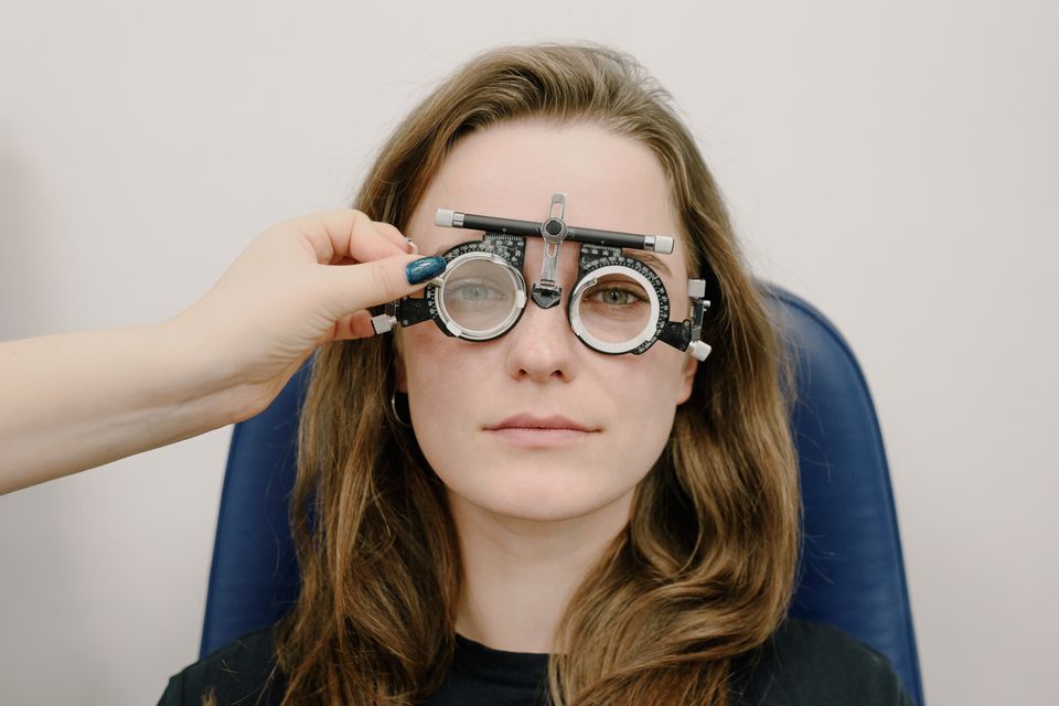 Ophthalmologist performing a detailed eye examination with a phoropter for cataract evaluation