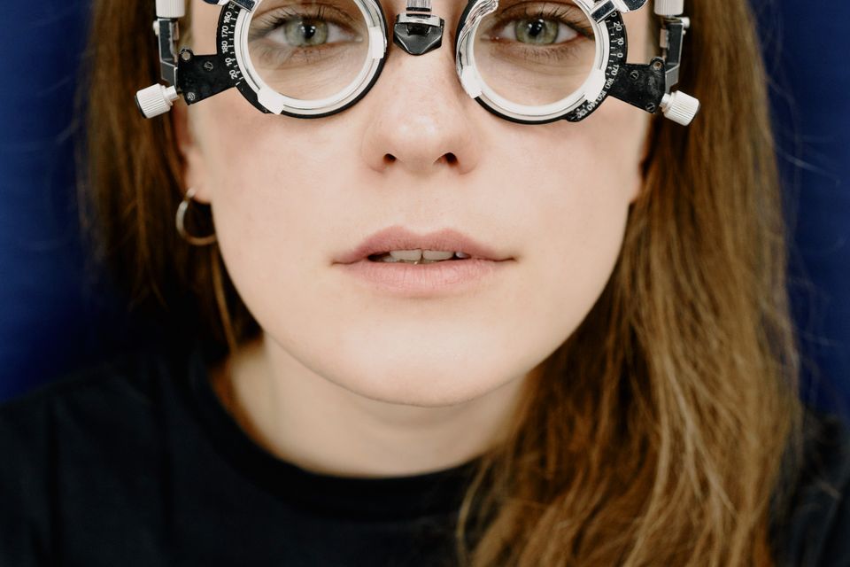 Patient wearing a trial frame during a squint and strabismus vision assessment